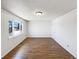 Bright bedroom featuring wood floors, a window and neutral colored walls at 630 S Youngfield Ct, Lakewood, CO 80228