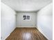 Simple bedroom featuring wood floors, a window, and closet with sliding doors at 630 S Youngfield Ct, Lakewood, CO 80228