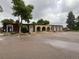 Office building featuring a covered entryway, large windows, and ample parking at 630 S Youngfield Ct, Lakewood, CO 80228