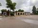 Office building featuring a covered entryway, large windows, and ample parking at 630 S Youngfield Ct, Lakewood, CO 80228