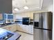 Well-equipped kitchen boasting stainless steel appliances, ample cabinetry, and bright lighting at 630 S Youngfield Ct, Lakewood, CO 80228