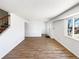 Spacious living room with hardwood floors, staircase, and a large bright window at 630 S Youngfield Ct, Lakewood, CO 80228