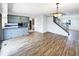 Bright living room showcasing stylish light fixture, wood floors, and access to the staircase at 630 S Youngfield Ct, Lakewood, CO 80228