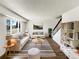 Bright living room featuring neutral paint, hardwood floors, and large windows at 630 S Youngfield Ct, Lakewood, CO 80228