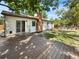 Spacious backyard with a wooden deck, lush lawn, and mature trees providing shade at 13784 W 67Th Way, Arvada, CO 80004