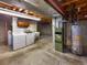 Unfinished basement laundry area with washer, dryer, utility sink, water heater, and furnace at 13784 W 67Th Way, Arvada, CO 80004