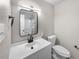Bathroom featuring a new vanity, mirror, light fixture and toilet at 13784 W 67Th Way, Arvada, CO 80004