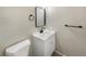 Clean and modern bathroom featuring a new vanity, mirror, and toilet at 13784 W 67Th Way, Arvada, CO 80004