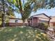 Charming brick and siding home with a well-maintained lawn and mature trees providing shade at 13784 W 67Th Way, Arvada, CO 80004