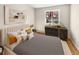 Comfortable main bedroom with a large window, hardwood floors, and stylish decor at 13784 W 67Th Way, Arvada, CO 80004