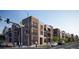 Modern apartment complex with pedestrians crossing the street, showcasing urban living at 1634 N Sheridan Blvd # 202, Denver, CO 80204