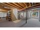 Unfinished basement with exposed beams, a staircase, and a window at 10383 Erin Pl, Lone Tree, CO 80124