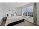 Well-lit bedroom with a comfortable bed and a large window providing natural light at 10383 Erin Pl, Lone Tree, CO 80124