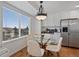 Eat-in breakfast nook features bright windows and a decorative lighting fixture at 10383 Erin Pl, Lone Tree, CO 80124