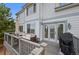 Cozy deck with comfortable outdoor seating, grill, and access to the home's interior at 10383 Erin Pl, Lone Tree, CO 80124