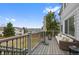 Outdoor deck with seating area, umbrella, and railing overlooking the backyard and neighborhood at 10383 Erin Pl, Lone Tree, CO 80124