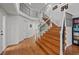 Spacious foyer with wood floors, a staircase with iron railings, and plenty of natural light at 10383 Erin Pl, Lone Tree, CO 80124