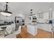 Bright kitchen features white cabinets, stainless steel appliances, an island and adjacent table at 10383 Erin Pl, Lone Tree, CO 80124