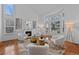 Living room showcasing large windows, modern decor, and a cozy fireplace at 10383 Erin Pl, Lone Tree, CO 80124