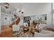 Bright open-concept living room with high ceilings, hardwood floors, a staircase, and an adjacent dining area at 10383 Erin Pl, Lone Tree, CO 80124