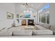 Spacious living room features a fireplace, built-in shelves, and vaulted ceilings at 10383 Erin Pl, Lone Tree, CO 80124
