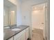 Bright bathroom featuring a gray vanity top, white cabinets and tile, and a combined shower and tub at 7357 S Yank Ct, Littleton, CO 80127
