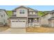 Charming two-story home featuring stone accents, neutral siding, a two-car garage, and a welcoming front porch at 7357 S Yank Ct, Littleton, CO 80127