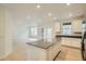 Modern open kitchen with white cabinets, stainless steel appliances, and center island with seating at 7357 S Yank Ct, Littleton, CO 80127