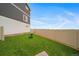 Spacious, fenced backyard with healthy green lawn and a solitary Adirondack chair at 22103 E 38Th Pl, Aurora, CO 80019