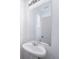 Bathroom featuring modern faucet, pedestal sink, and vanity mirror at 22103 E 38Th Pl, Aurora, CO 80019