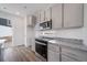 Modern kitchen with stainless steel appliances, grey cabinets and granite countertops at 22103 E 38Th Pl, Aurora, CO 80019