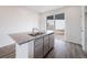Kitchen island featuring stainless steel dishwasher and a granite countertop at 22103 E 38Th Pl, Aurora, CO 80019