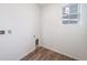 Clean laundry room with wood-look floors and essential hookups at 22103 E 38Th Pl, Aurora, CO 80019