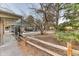 Backyard with rustic wooden fence, patio and metal security gate, blending natural elements with secure outdoor living at 21577 Mountsfield Dr, Golden, CO 80401