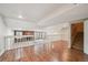 Large basement with wood flooring, stone fireplace, and sliding glass doors to the backyard at 2609 S Quebec S St # 20, Denver, CO 80231