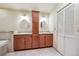 Bathroom featuring double sinks, granite countertops, and a central cabinet at 2609 S Quebec S St # 20, Denver, CO 80231