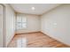 Cozy bedroom featuring pristine hardwood floors, a large window, and neutral wall paint at 2609 S Quebec S St # 20, Denver, CO 80231