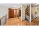 Inviting entryway with hardwood floors, staircase with metal railings, and mirrored closet doors at 2609 S Quebec S St # 20, Denver, CO 80231