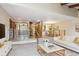 Open-concept living room featuring railings, a dining area, and a white sofa with gold pillows at 2609 S Quebec S St # 20, Denver, CO 80231