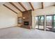 Bright living room with vaulted ceiling, brick fireplace, and access to the outdoor deck through sliding doors at 2609 S Quebec S St # 20, Denver, CO 80231