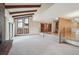 Spacious living room featuring vaulted ceilings, exposed beams, and large windows at 2609 S Quebec S St # 20, Denver, CO 80231