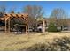 Grassy backyard area with a wooden pergola seating area at 11307 Navajo Cir # A, Westminster, CO 80234
