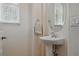 Charming half bathroom with pedestal sink, oval mirror, and natural light at 11307 Navajo Cir # A, Westminster, CO 80234