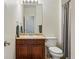 Cozy bathroom featuring a single sink vanity, toilet, and neutral decor for a clean and inviting space at 11307 Navajo Cir # A, Westminster, CO 80234