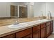Bathroom featuring double sinks with granite countertops, and a large mirror at 11307 Navajo Cir # A, Westminster, CO 80234