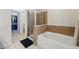 Bathroom featuring a bathtub and glass enclosed shower with tile surround at 11307 Navajo Cir # A, Westminster, CO 80234