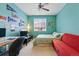 Bedroom featuring a comfortable bed, natural light, and a lively atmosphere with colorful decorations at 11307 Navajo Cir # A, Westminster, CO 80234