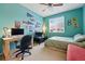 Bright bedroom featuring a spacious desk, comfortable bed, and natural light from the window at 11307 Navajo Cir # A, Westminster, CO 80234