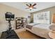 Cozy bedroom with a striped bed, ceiling fan, and workout area at 11307 Navajo Cir # A, Westminster, CO 80234