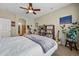 Bright bedroom with striped bedding, ceiling fan, and ensuite bathroom at 11307 Navajo Cir # A, Westminster, CO 80234
